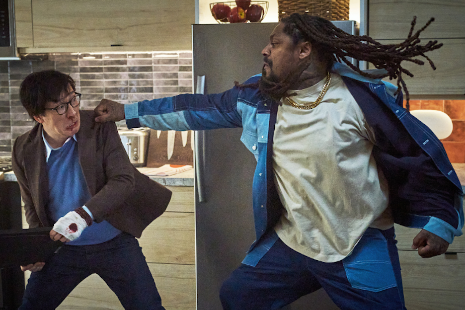 caption: Ke Huy Quan and former Seahawks running back Marshawn Lynch in a fight scene for "Love Hurts," slated to be released in movie theaters in 2025.