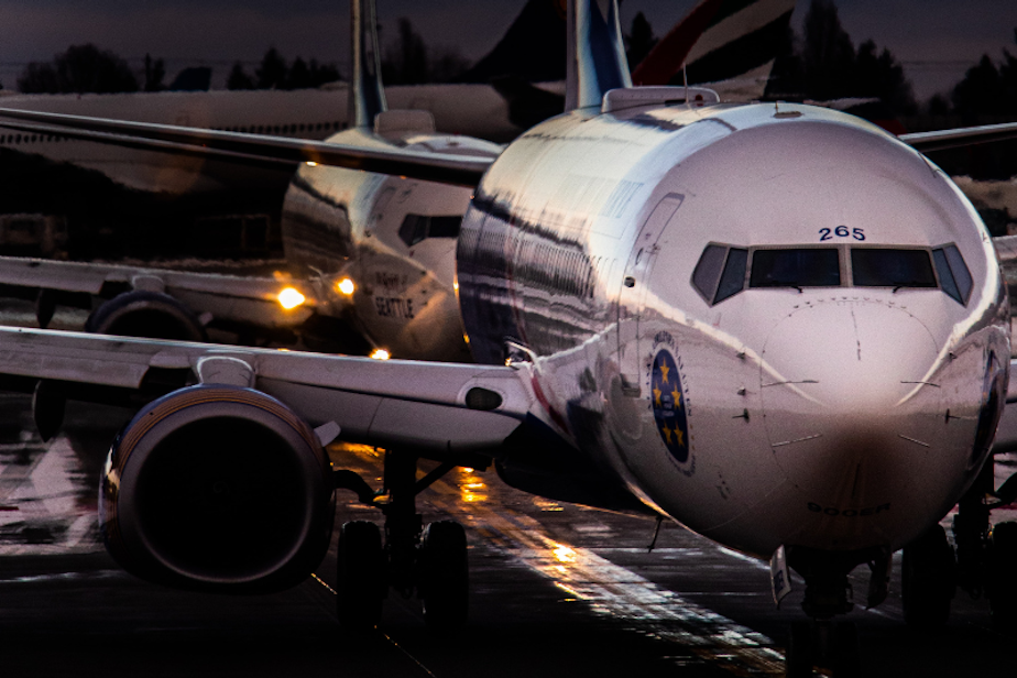 caption: Planes lineup for runway clearance at Sea-Tac International Airport.