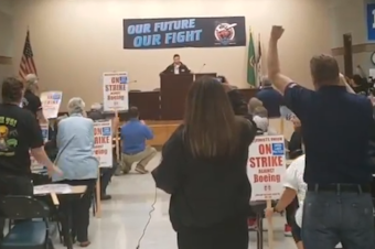 caption: Washington's branch of the International Association of Machinists and Aerospace Workers, representing Boeing employees, vote to reject a contract offer from the company and to also authorize a strike on the evening of Sept. 12, 2024. 
