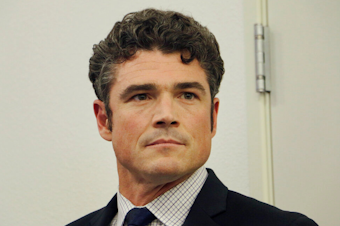caption: Republican candidate Joe Kent waits before taking the stage for a debate with Democratic candidate Marie Gluesenkamp Perez in the race for the 3rd Congressional District, Tuesday, Sept. 27, 2022, in Vancouver, Wash. 